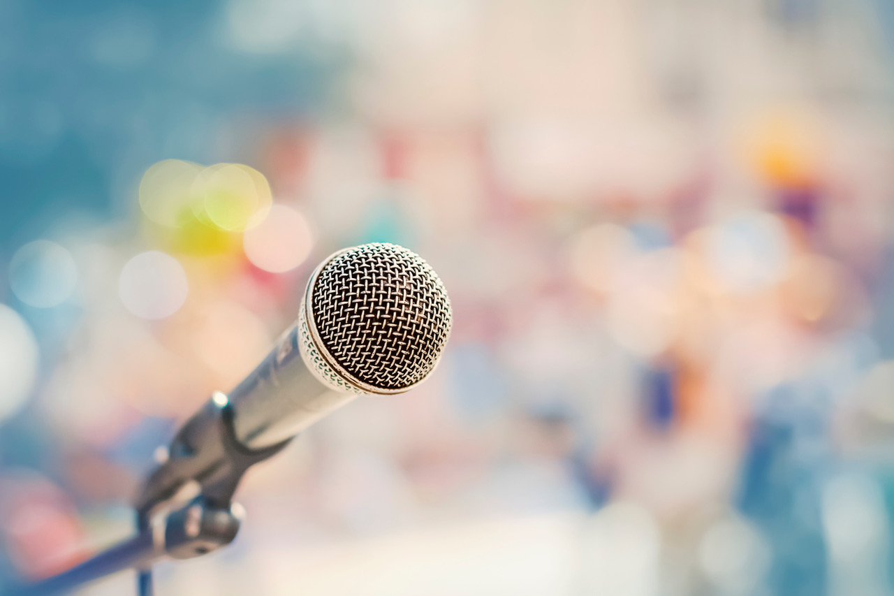 Microphone on the stand on the background of the street in defocus